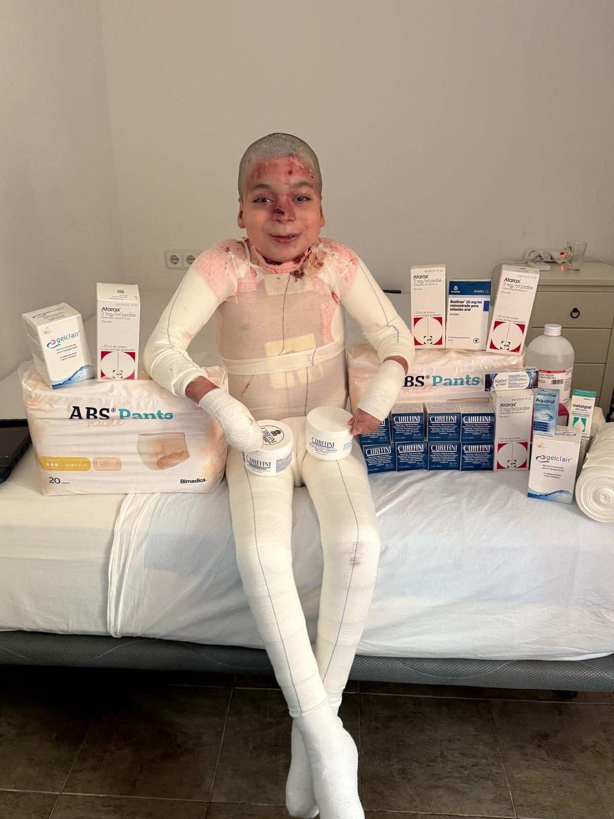 Jesus with some of the bandages, creams, and medicine needed each month.